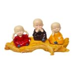 3 Baby Monks Sitting On Tree
